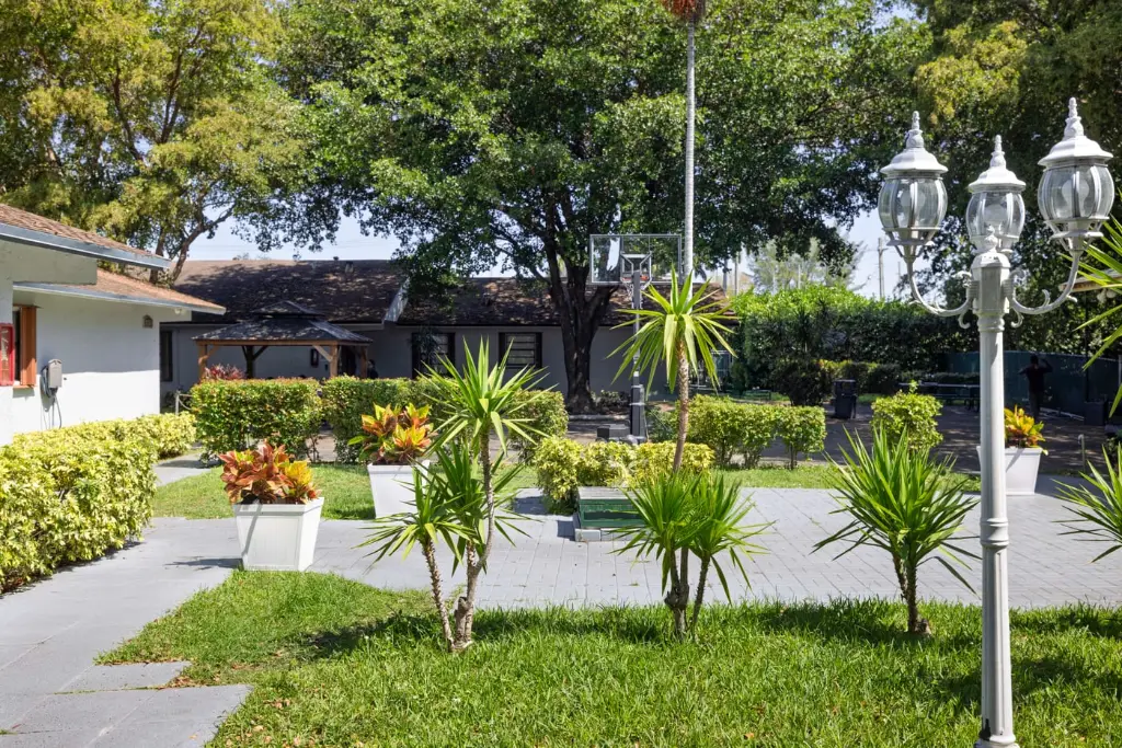 Landscaped campus walkway and gardens at Harbor Village rehab in Miami